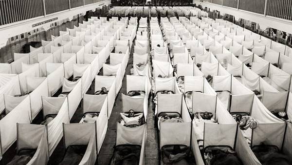 Containment zone in a barracks in San Francisco. Beds are equipped with «anti-sneeze» walls. 1918.